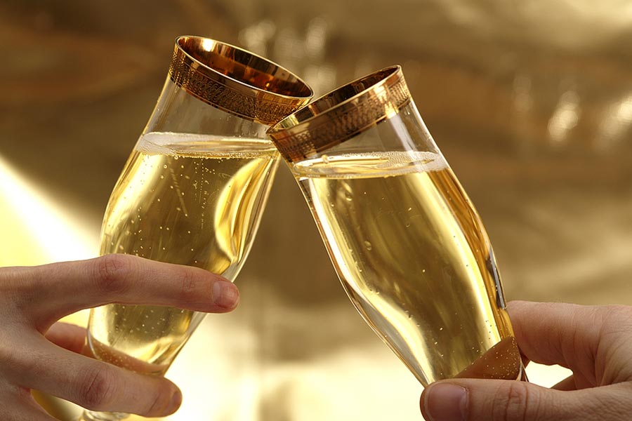 Two glasses toasting with sparkling wine
